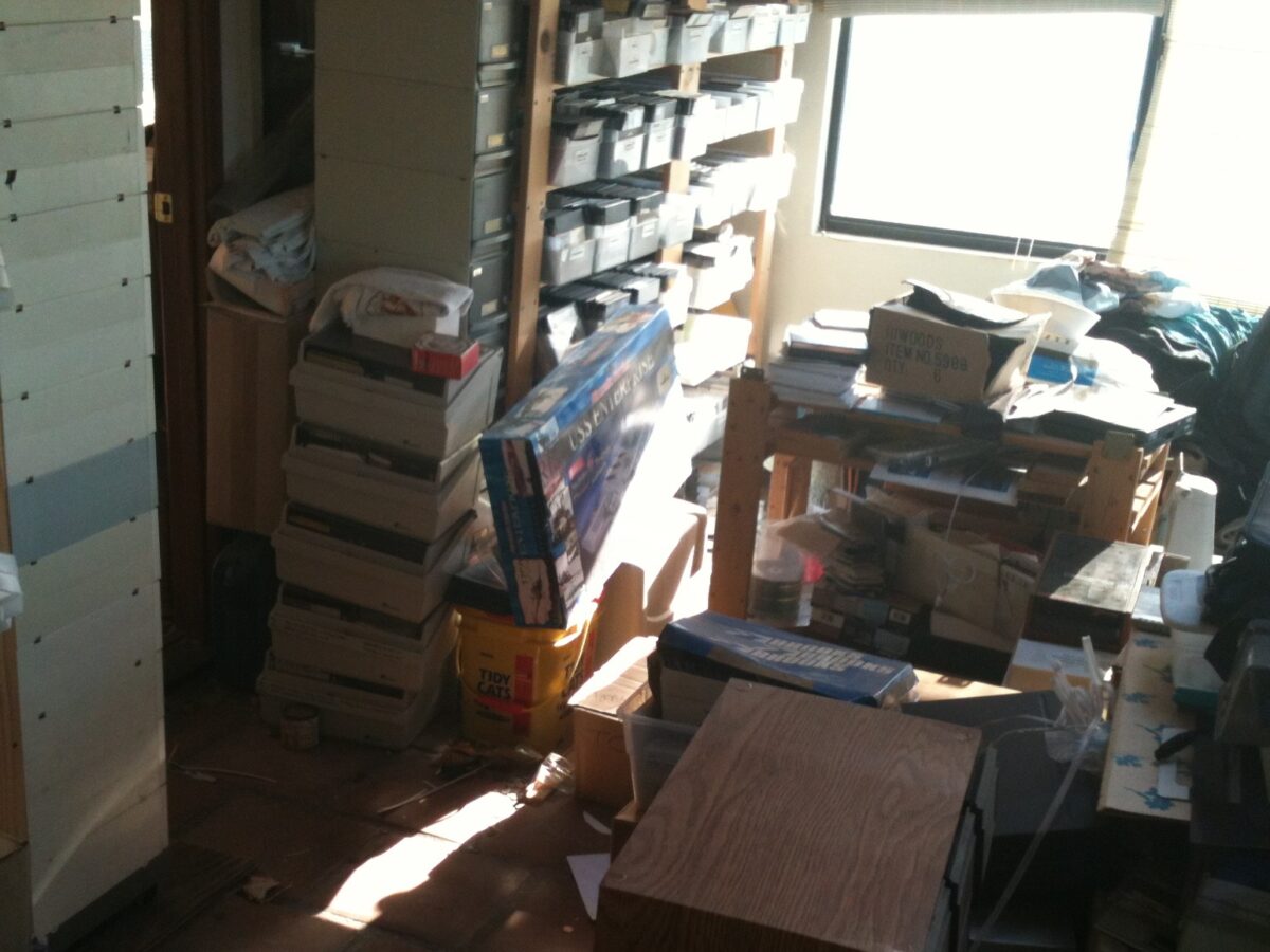 Piles of Apple II hardware and software in a house