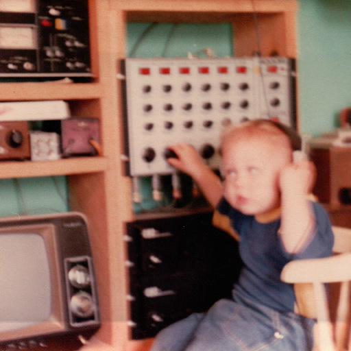 A little kid sitting on a chair in front of a computer