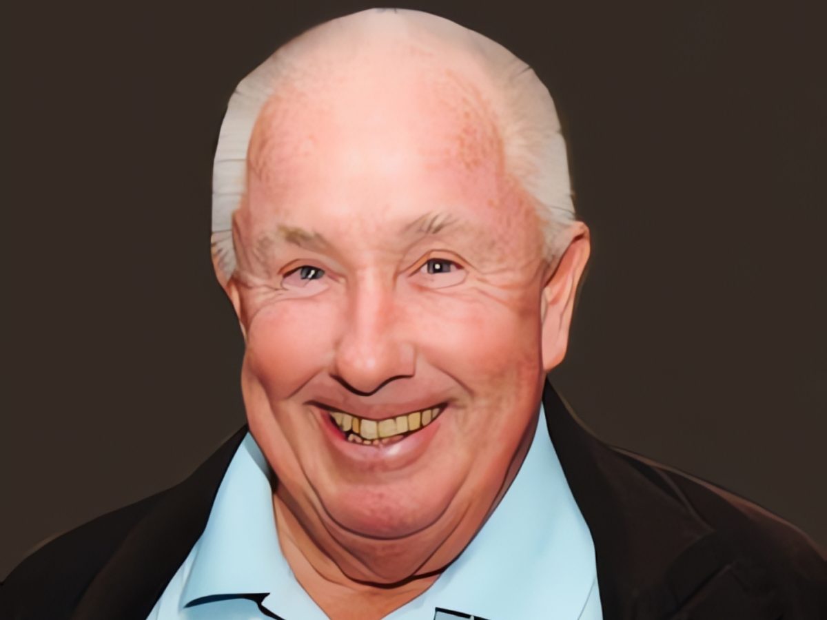Headshot of a smiling, balding white man
