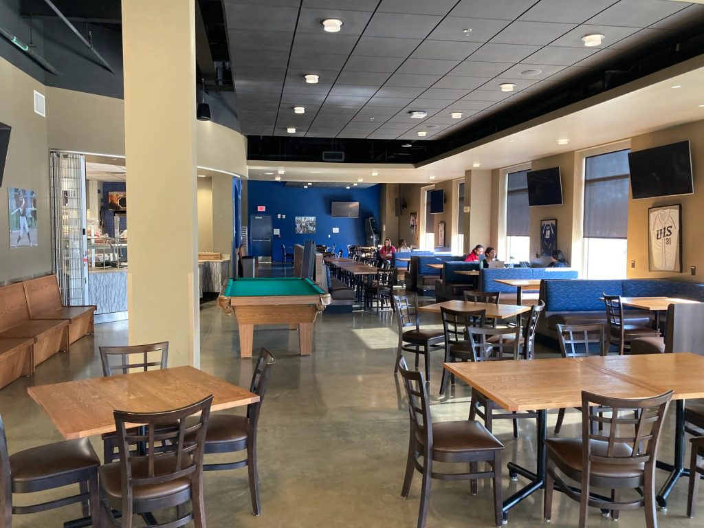 A dining hall with a pool table
