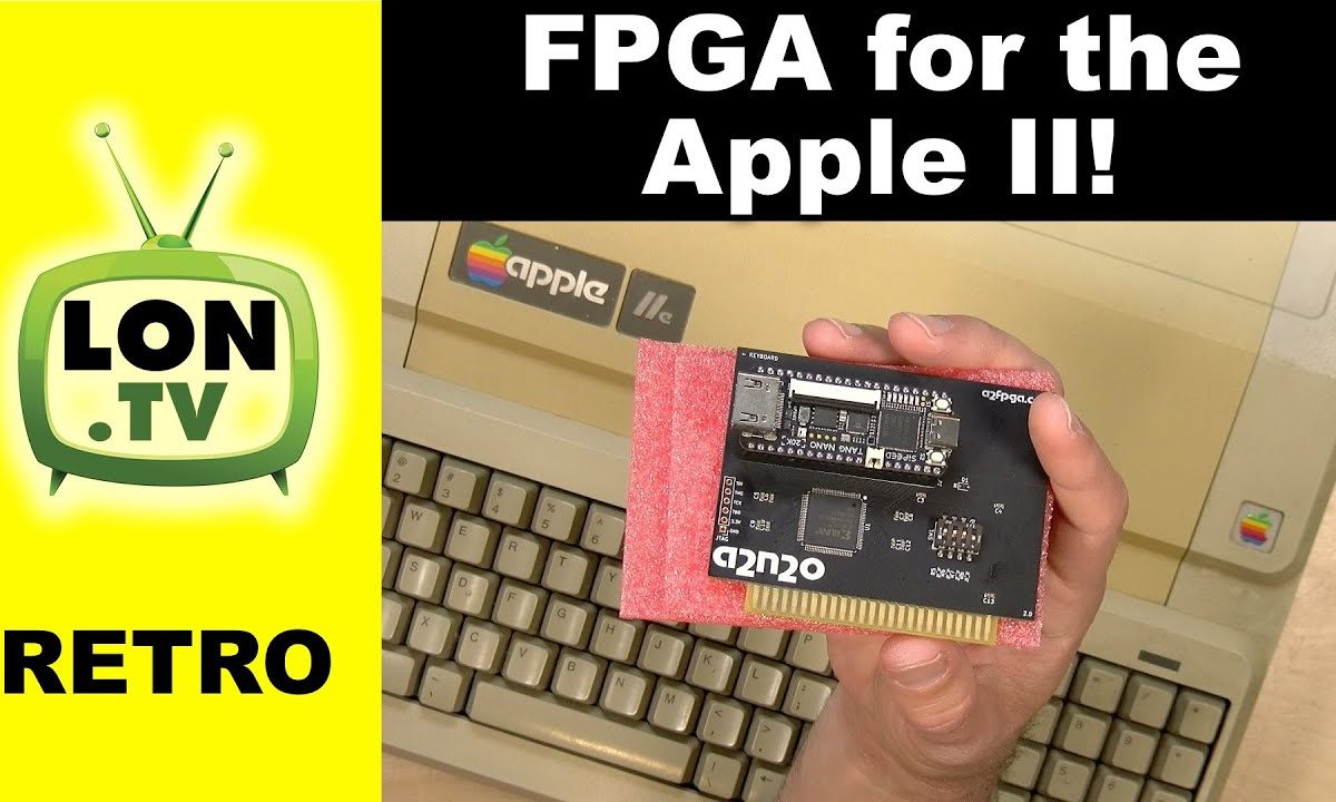 A hand holding an Apple II peripheral card over an Apple IIe case